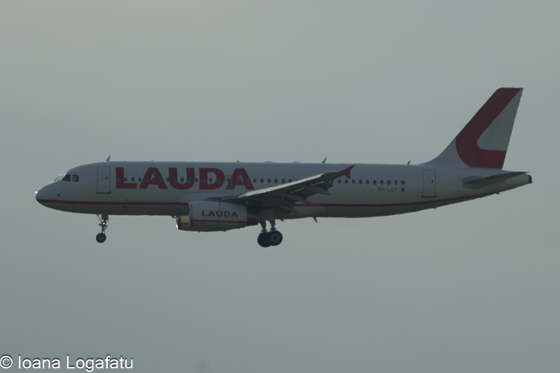 Airplane descends under cloudy skies at twilight